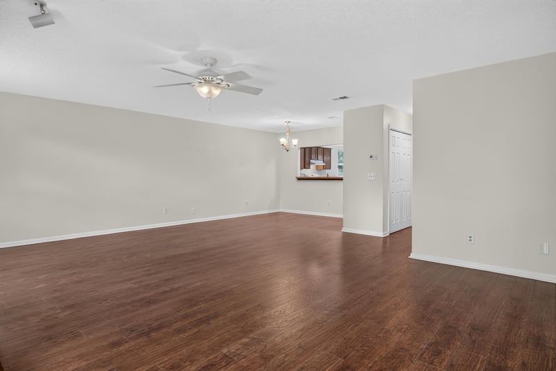 Open living area with wood floors and ceiling fan at 4427 Millstone Ct, Jacksonville, FL