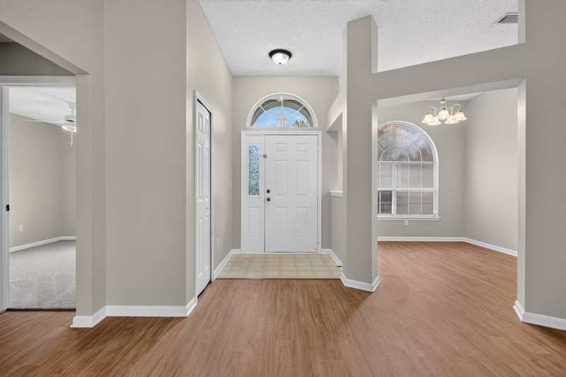 Foyer with entry door and wood floor at 12949 Chets Creek Dr S, Jacksonville, FL 32224