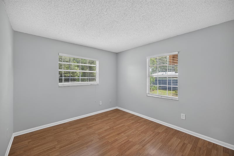 Bedroom with wood laminate floor and window at 328 Palos Ct, St. Augustine, FL