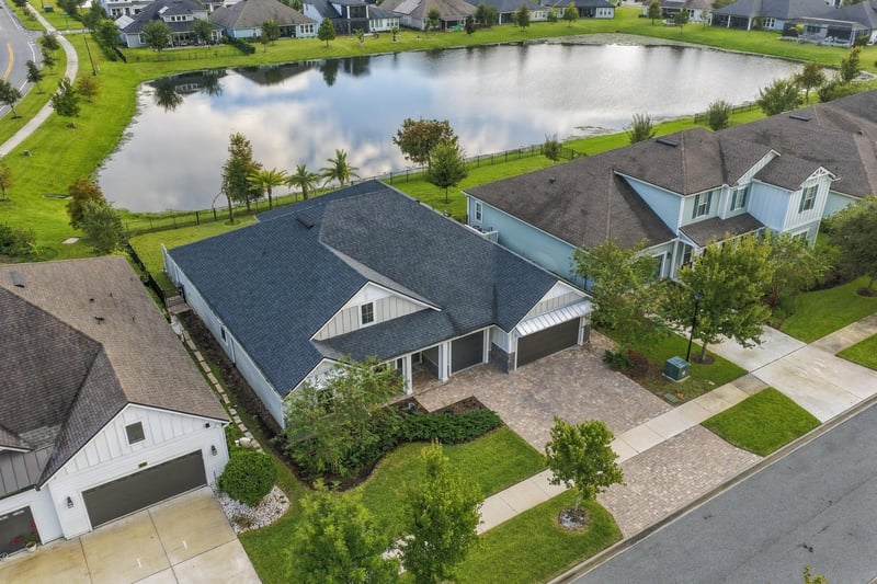 Aerial view of the home, driveway and pond at 3921 Spyglass Hill Ln