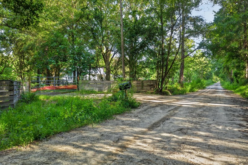 Dirt road entrance lined with trees at 55520 Jewel-Thomas Rd, Callahan, FL 32011