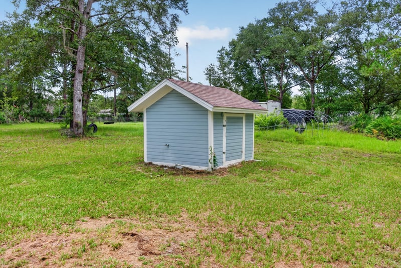 Small white storage shed in the yard at 4890 McAllister Rd, Middleburg, FL 32068
