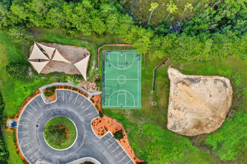 Drone view of basketball court and natural play area in River Glen