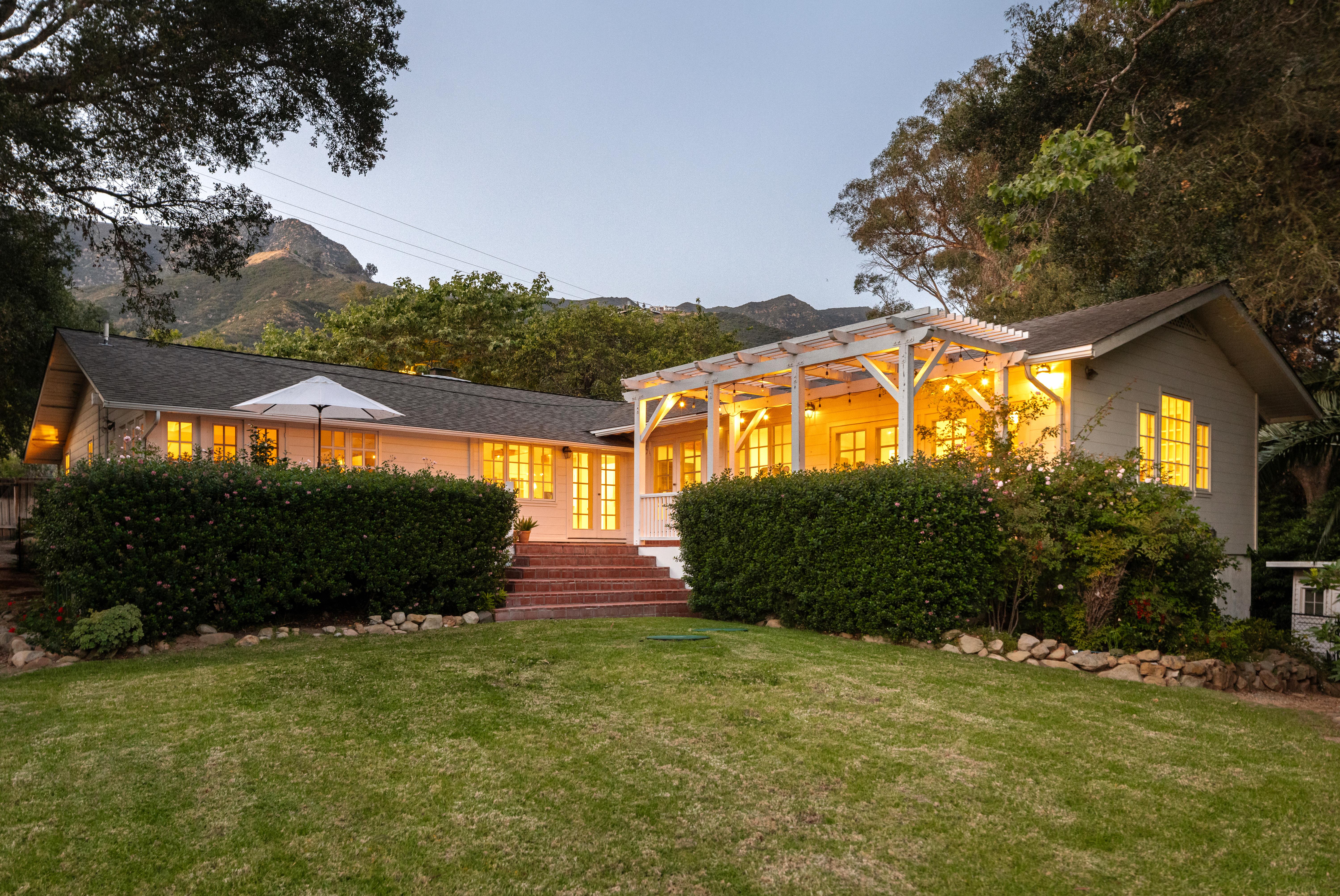 Exterior twilight photography of luxury residence at 2915 Hidden Valley Ln, Santa Barbara — warm evening light falls across the facade as the Santa Ynez Mountains recede into dusk in this professional real estate photography portfolio by VirTour Media. Our team captured still photography, aerial drone photography, and twilight photography from late afternoon through twilight.