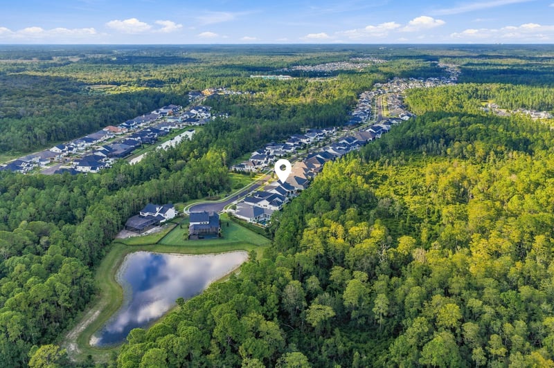 Aerial view of the neighborhood with pond and wooded surroundings in Ponte Vedra Beach