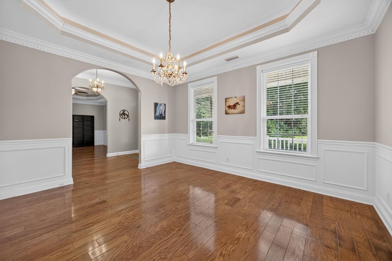 Formal living room with arched doorways and chandelier at 1735 Hagans Ridge Ct