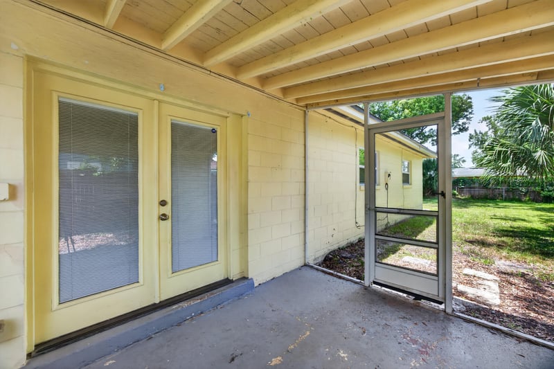 Covered patio with French doors and screened porch at 5527 Beney Rd, Jacksonville, FL 32207