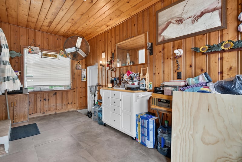 Wood-paneled utility room with cabinets at 5745 110th St, Jacksonville, FL 32244