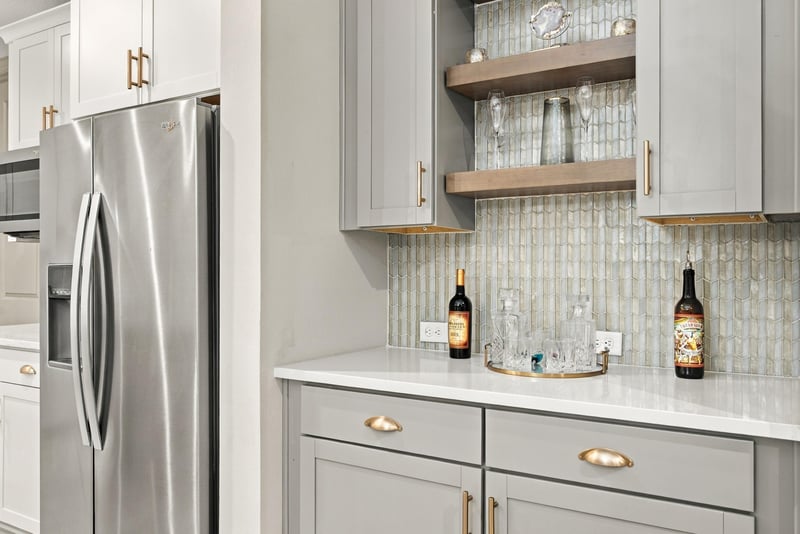 Kitchen wet bar nook with open shelving at 3921 Spyglass Hill Ln