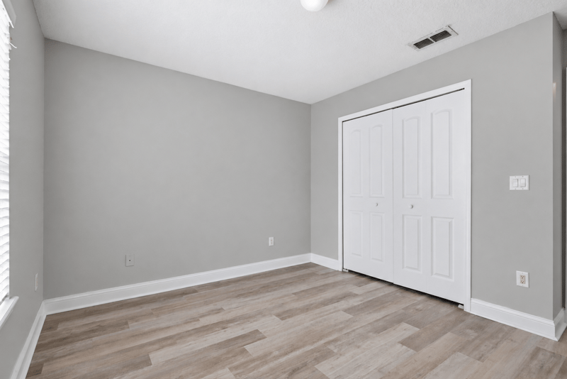 Bedroom with closet and wood-look flooring at 14187 Big Spring St, Jacksonville, FL 32258