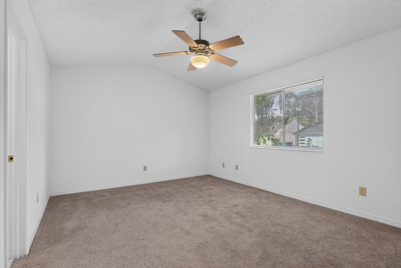 Carpeted bedroom with ceiling fan at 1445 Classic Oak Rd W, Jacksonville, FL