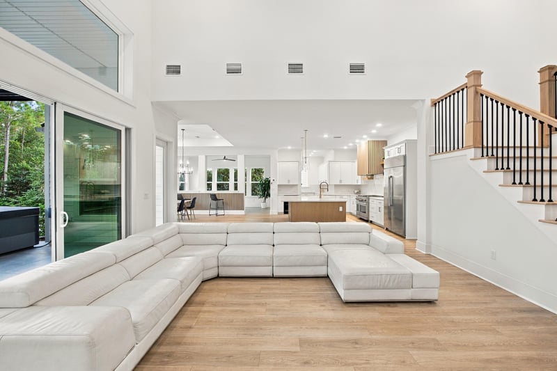 Great room with sectional sofa and sliding glass doors at 907 Seagrove Dr, Ponte Vedra Beach, FL 32081