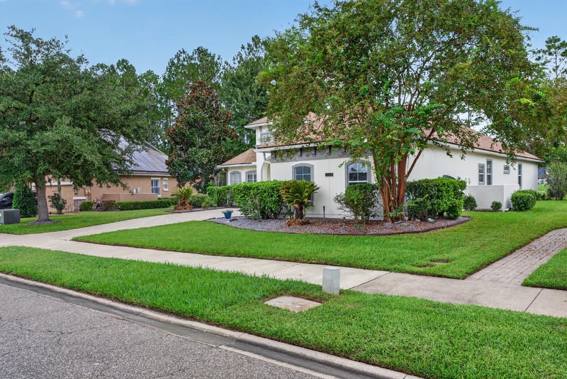 Front exterior with curved driveway and landscaped lawn at 4109 Eagle Landing Pkwy, Orange Park, FL 32065