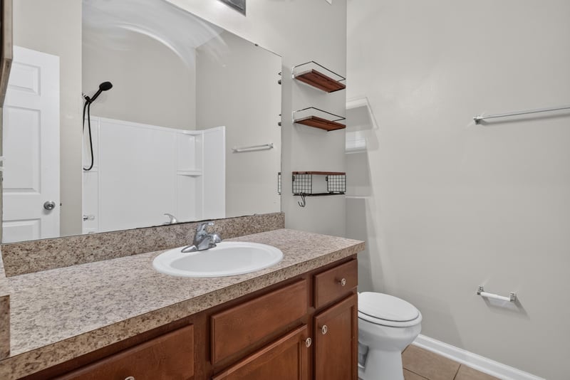 Bathroom vanity with open shelving at 8196 Cabin Lake Cir, Jacksonville, FL 32256