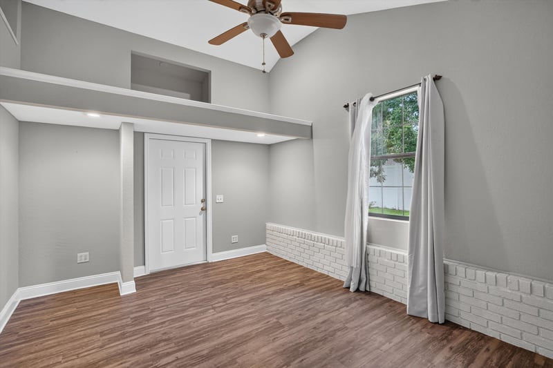 Bedroom with brick wainscot and wood floor at 12344 Cormorant Ct, Jacksonville, FL