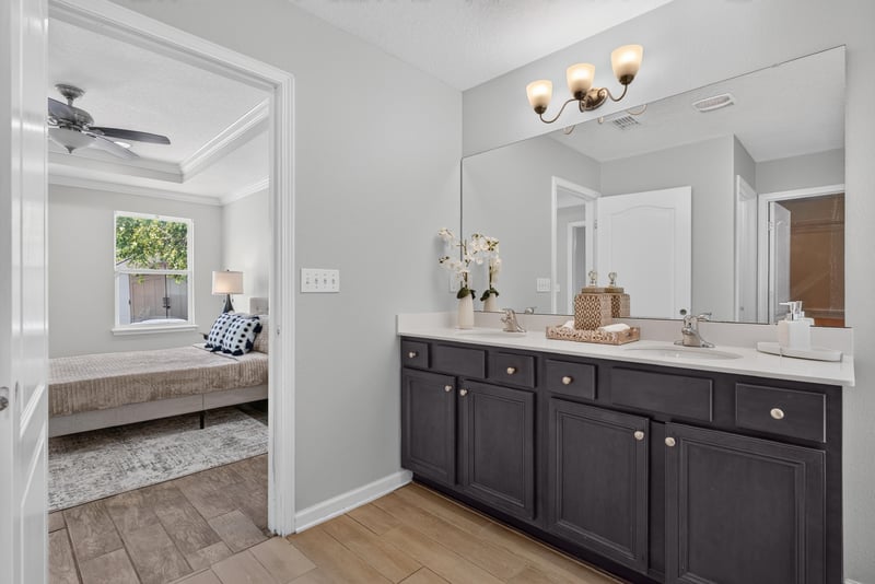 Bathroom vanity with double sinks and large mirror at 10066 Andean Fox Dr, Jacksonville, FL 32222