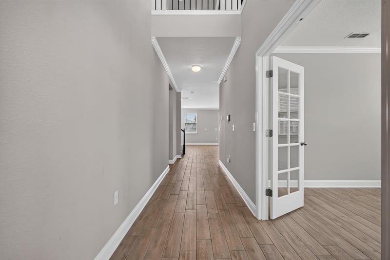 Entry hallway with wood floor and French doors at 2580 Cold Stream Ln, Green Cove Springs, FL 32043