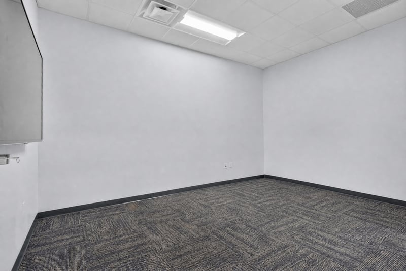 Empty corner room with carpet flooring at 7240 Golden Wings Rd building 100, Jacksonville, FL 32244