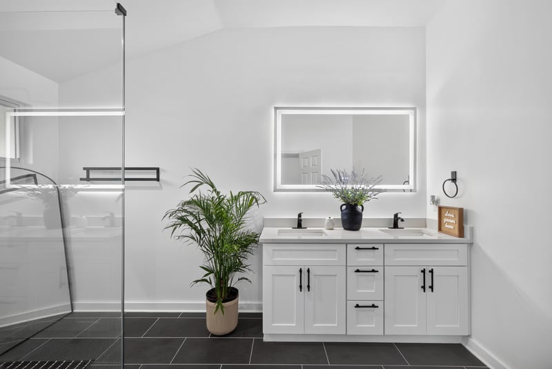Bathroom with dual vanity and glass shower at 8921 Needlepoint Pl, Jacksonville, FL 32244