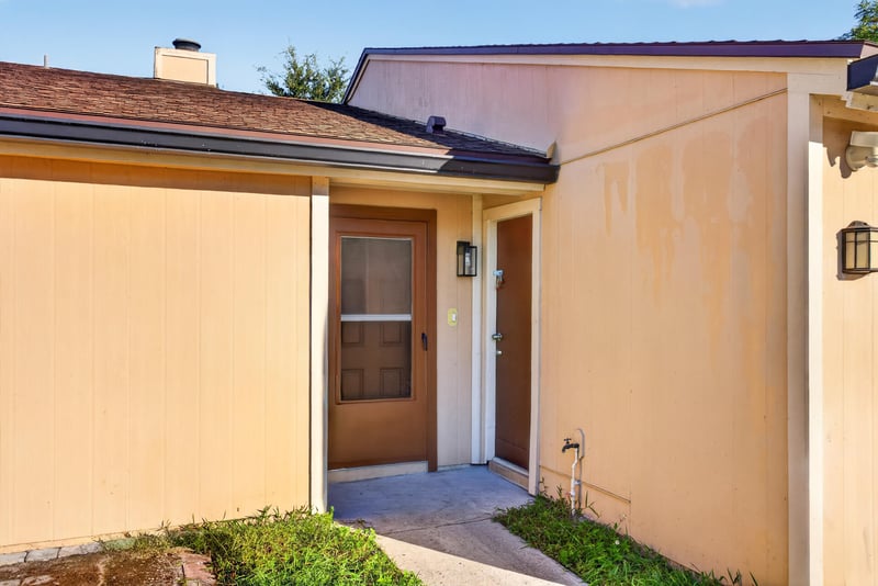 Front entry door with glass panel and sconce at 8177 Virgo St, Jacksonville, FL 32216