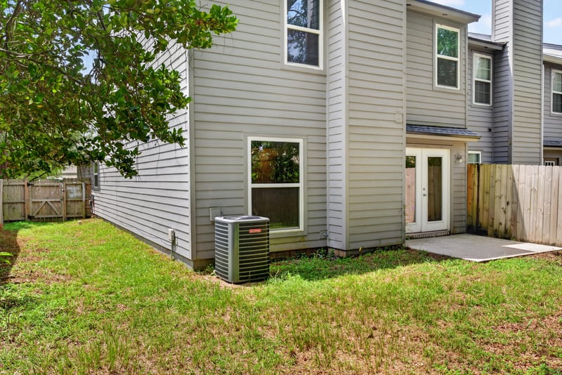 Rear exterior with AC unit and yard at 4427 Millstone Ct, Jacksonville, FL