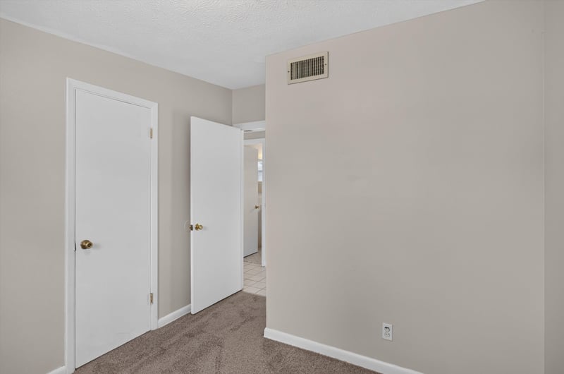Hallway with carpet and multiple doors at 87 Saratoga Cir S, Atlantic Beach, FL