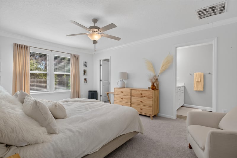 Primary bedroom with wood dresser at 1186 Beach Dune Dr, Jacksonville, FL 32233