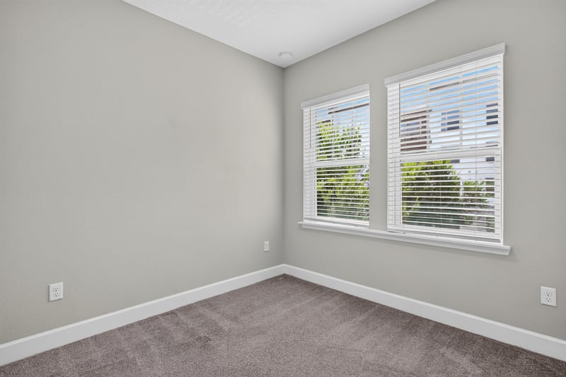 Bedroom with window and carpet at 7446 Loggerhead Ct, Jacksonville, FL 32256