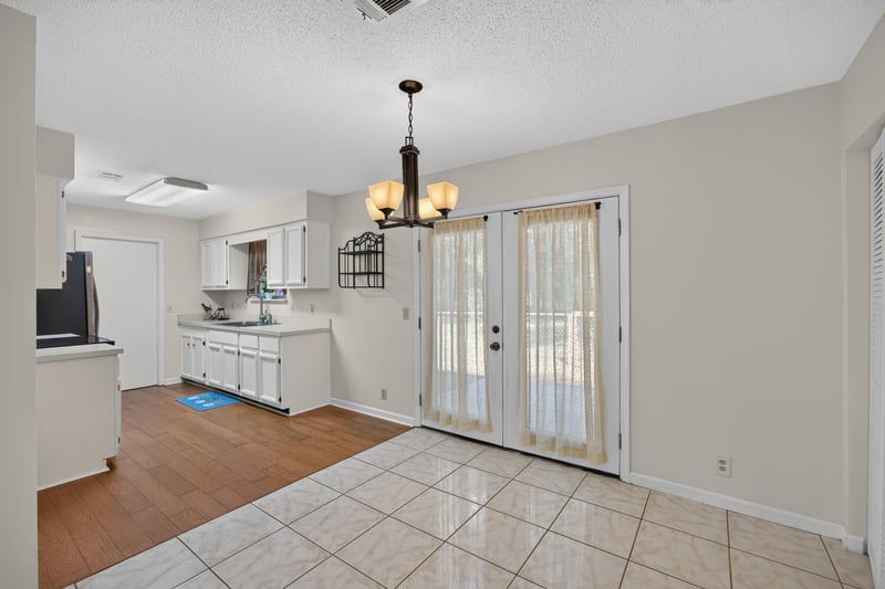 Dining area with glass doors and view into kitchen at 2829 Blackberry Ave