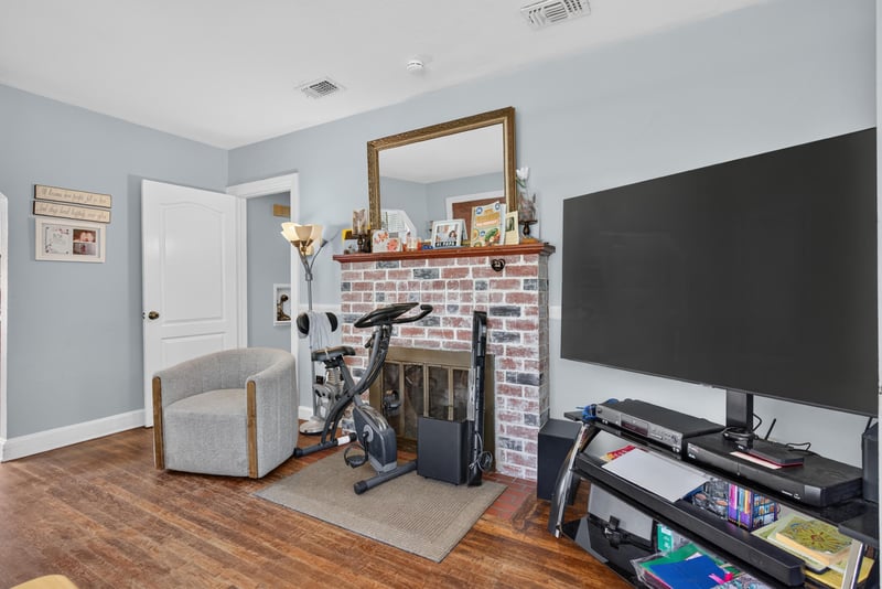 Living room with television and brick fireplace at 5745 110th St, Jacksonville, FL 32244