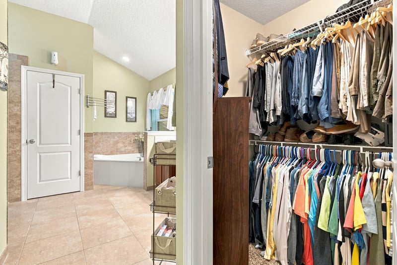 Primary bedroom with ceiling fan and window at 10923 Black Diamond Ct, Jacksonville, FL