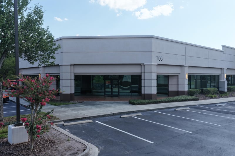 Building front with crape myrtle and parking lot at 10550 Deerwood Park Blvd, Jacksonville, FL 32256