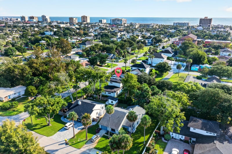 Aerial view of the neighborhood with the ocean and city in the distance in Jacksonville Beach, FL