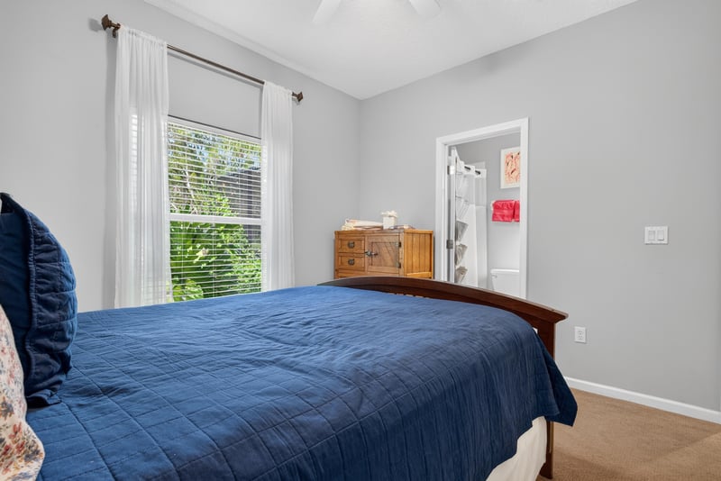 Bedroom with navy bedding and windows at 2304 Spring Hill Ct, Orange Park, FL