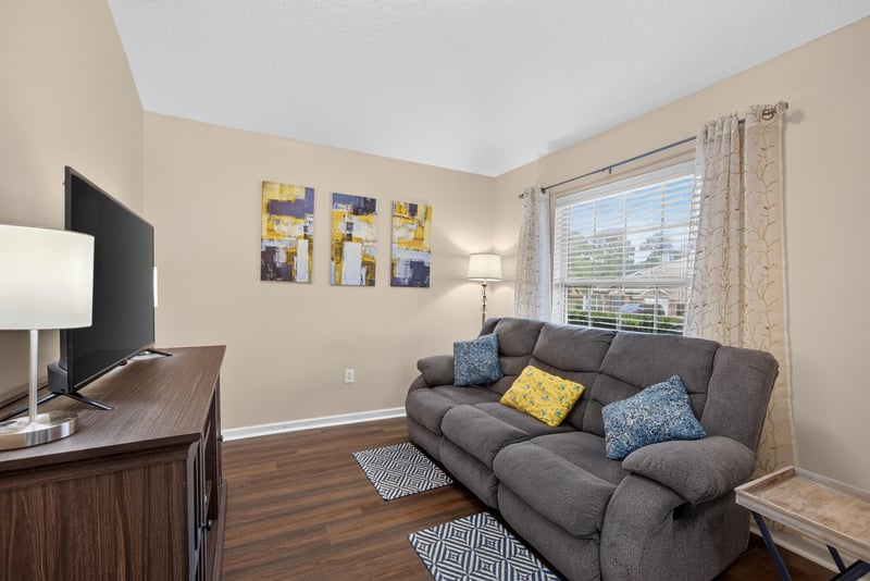 Living area with sectional sofa and TV stand at 3112 Silverado Cir, Green Cove Springs, FL 32043