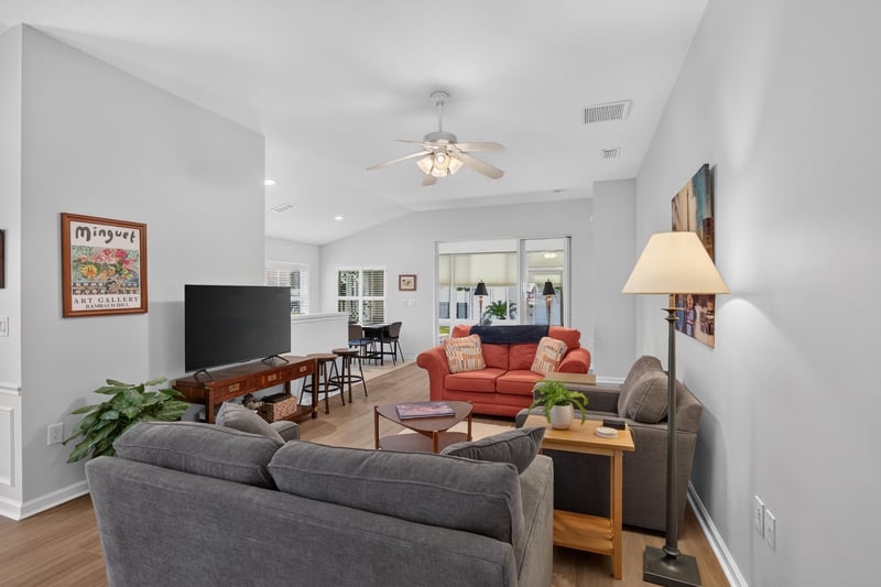 Living room with wood flooring and ceiling fan at 11225 Water Spring Cir, Jacksonville, FL 32256