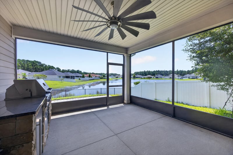 Screened lanai with outdoor kitchen and ceiling fan at 855 Flach Dr, St. Johns, FL