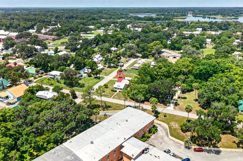 Drone view of neighborhood and lake in Crescent City, FL