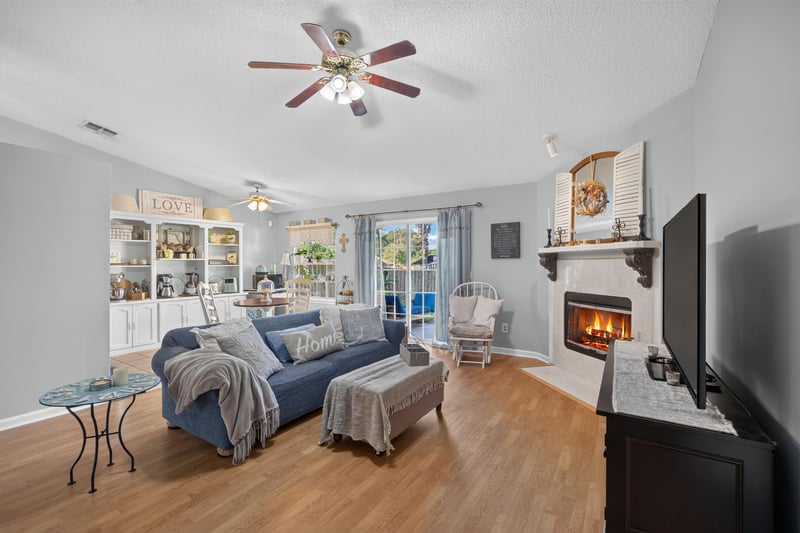 Living room with built-in shelving and fireplace at 4556 Shaky Leaf Ln N, Jacksonville, FL 32224