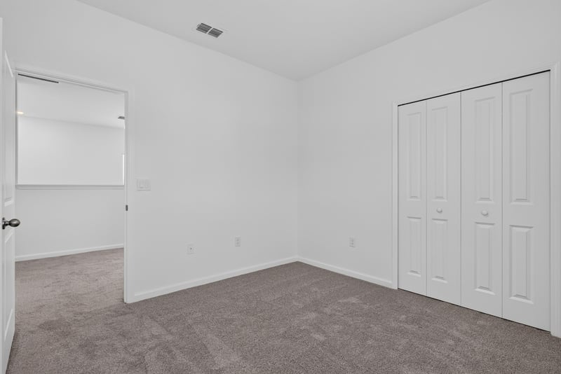 Empty carpeted bedroom with window at 269 Bluegrass Wy, St. Augustine, FL 32092