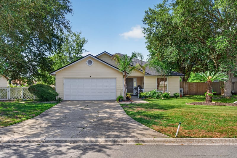 Front exterior and driveway in daylight at 8680 Bandera Cir S, Jacksonville, FL 32244