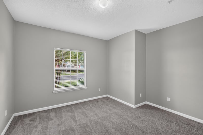 Bedroom with window and carpet at 575 Oakleaf Plantation Pkwy, Orange Park, FL 32065
