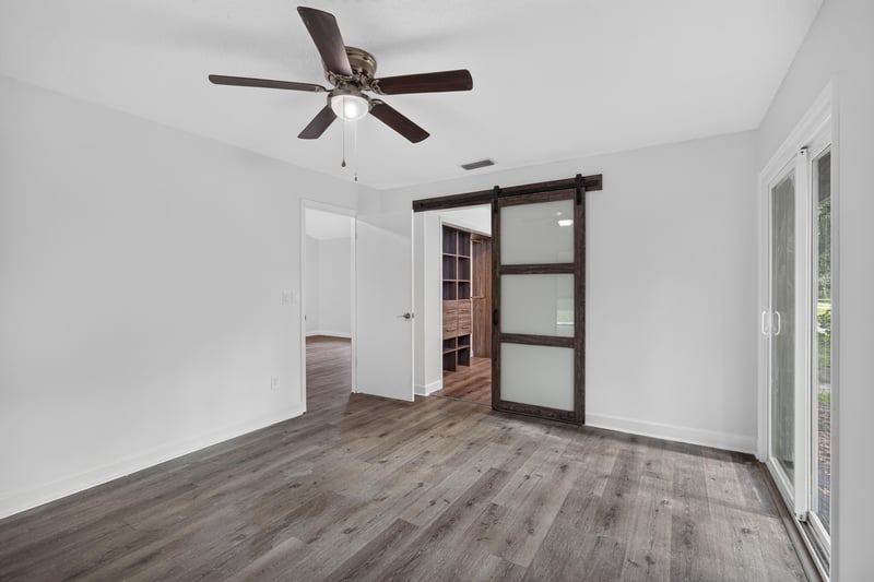 Room with barn door and wood floor at 551 Deltona Blvd, St. Augustine, FL 32086