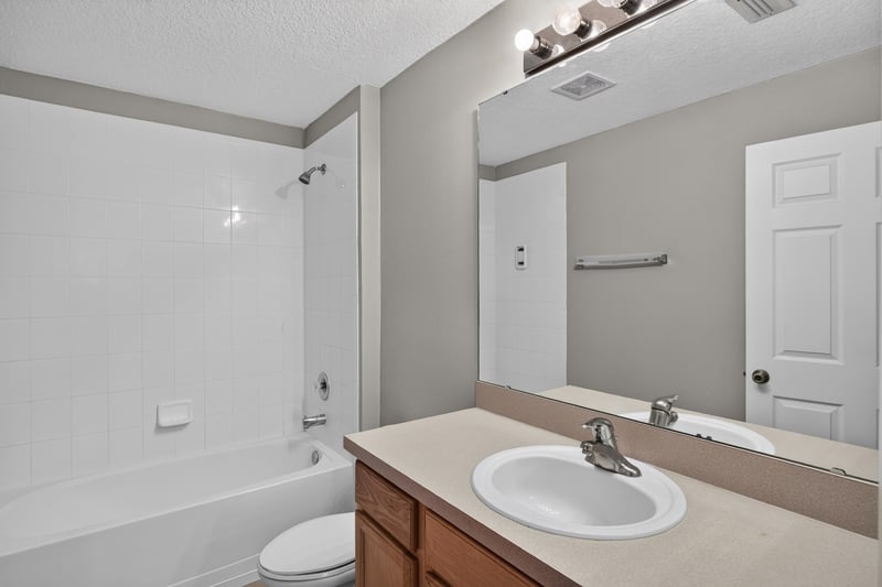 Bathroom vanity with mirror lighting at 575 Oakleaf Plantation Pkwy, Orange Park, FL 32065