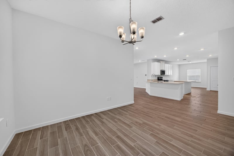 Open living and kitchen area with wood-look flooring at 9905 Ansley Lake Dr, Jacksonville, FL