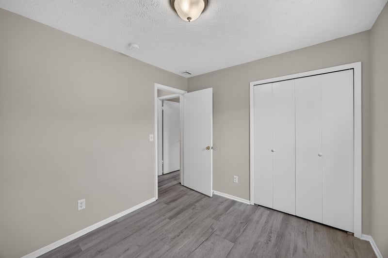 Empty bedroom with double closets and wood-look flooring at 1083 Stokes St, Jacksonville, FL