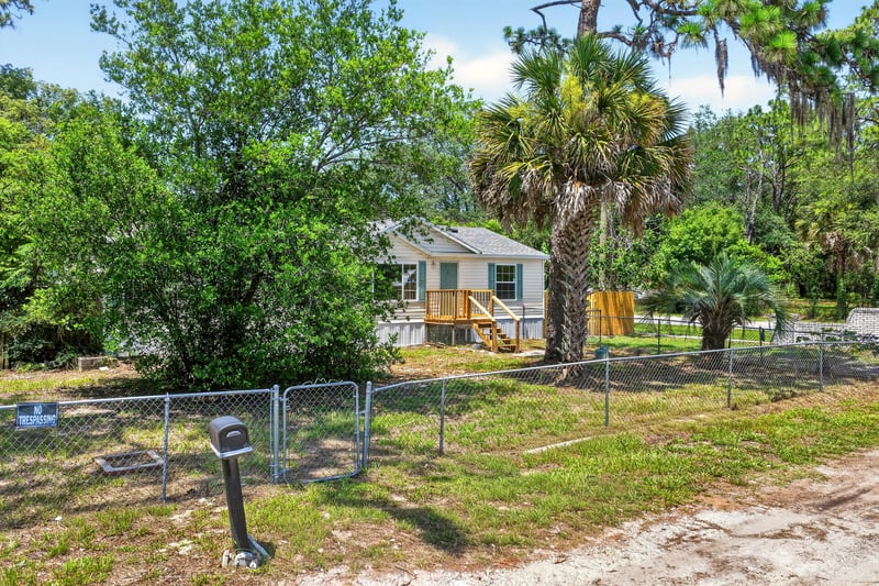 Front exterior with mailbox and fencing at 7603 Coach Park Dr, Jacksonville, FL 32244