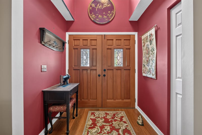 Entry foyer with wood double doors and red walls at 4837 Pareja Ct, Jacksonville, FL 32225