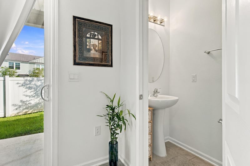 Half bath with pedestal sink and window at 8359 Zenith Cir, Jacksonville, FL 32256