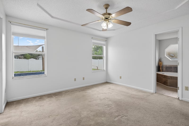 Bedroom with ceiling fan and closet door at 2164 Orangewood St, Middleburg, FL 32068